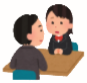 机に向かい合って話し合っている、赤いリボンの女子生徒と男性教諭のイラスト