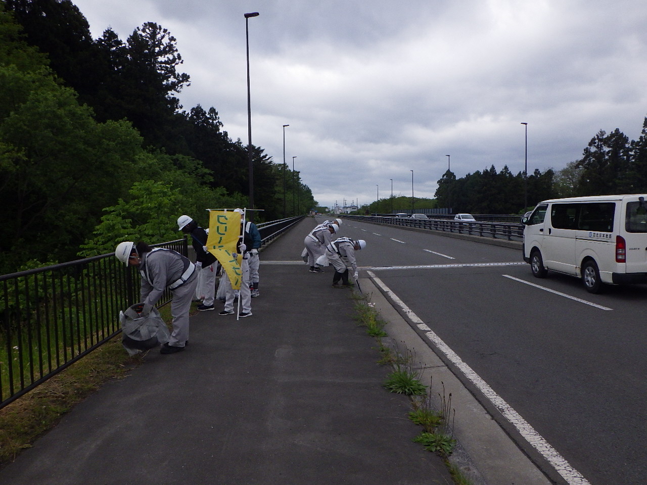 道路脇の草地のごみを拾う写真1