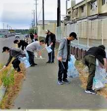 道路脇の草地のごみを拾う写真3