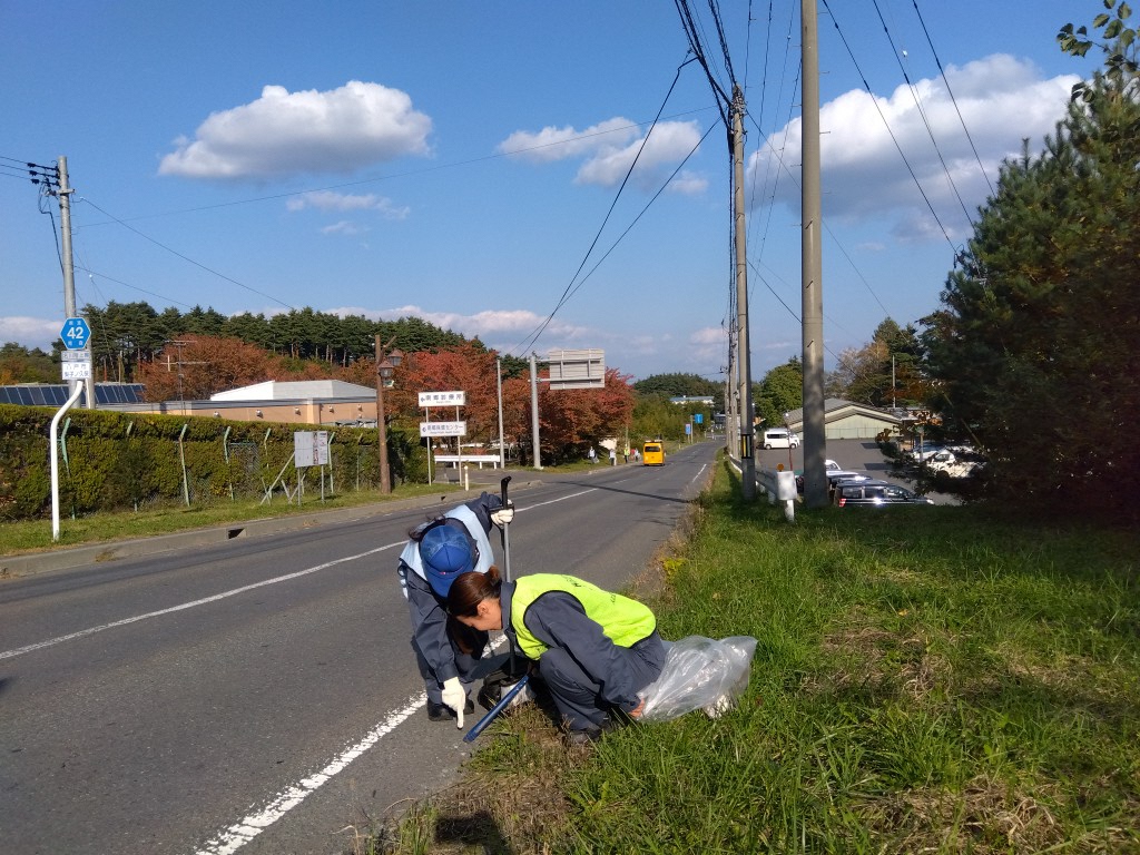 しゃがんでごみを拾っている様子
