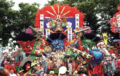 赤青黃の鬼の頭が装飾された八戸三社大祭の山車の写真