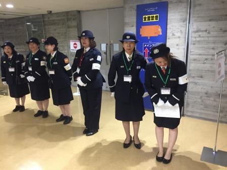室内にて制服の女性隊員たちが横一列になって並んでおり、右の女性がお辞儀をしている写真